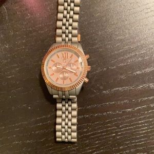 Watch with grey metal band.